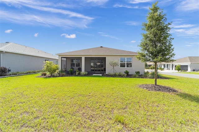 7706 SW 89th Ct, Ocala, FL 34481 - view of front of house with a front lawn, a sunroom, and stucco siding