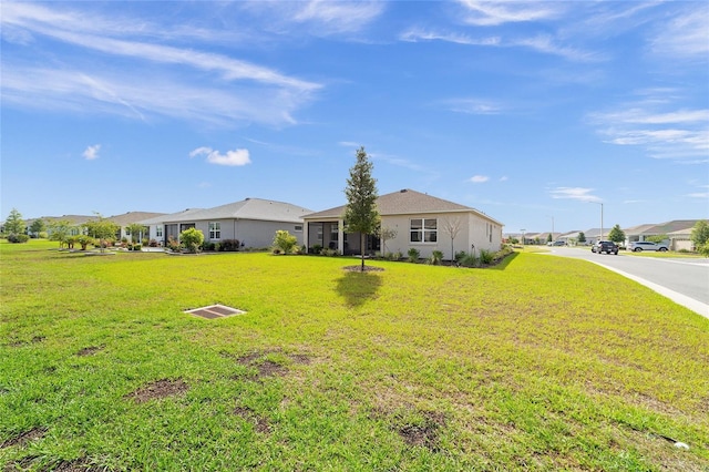 7706 SW 89th Ct, Ocala, FL 34481 - view of front of house featuring a front lawn, stucco siding, and a residential view