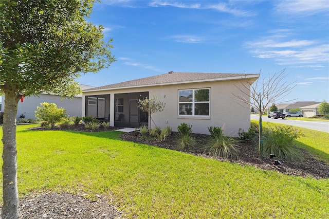 7706 SW 89th Ct, Ocala, FL 34481 - view of front facade with a front yard, stucco siding, a sunroom, and a shingled roof