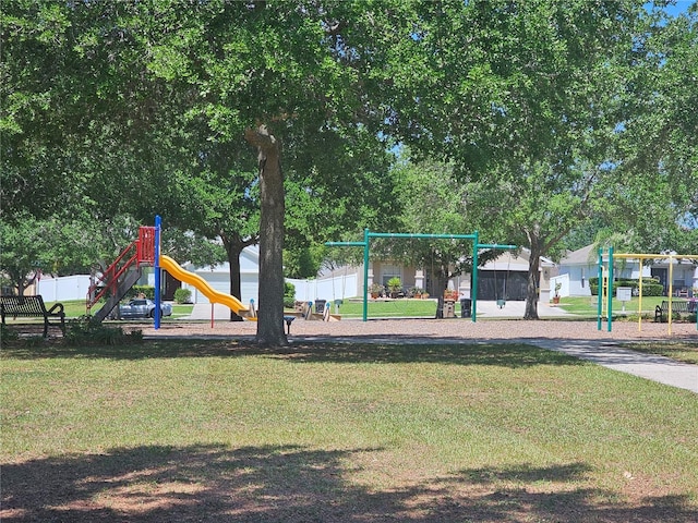 community playground with a lawn and fence