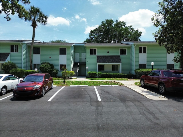 view of property with uncovered parking