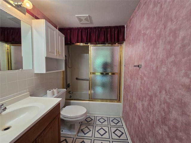 bathroom featuring tile patterned flooring, vanity, toilet, enclosed tub / shower combo, and visible vents