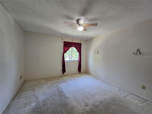 unfurnished room featuring carpet floors, a textured ceiling, and ceiling fan