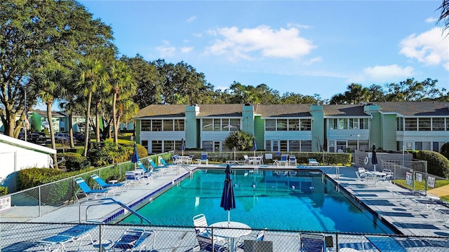 pool with fence and a patio area