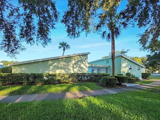 view of side of property with a yard