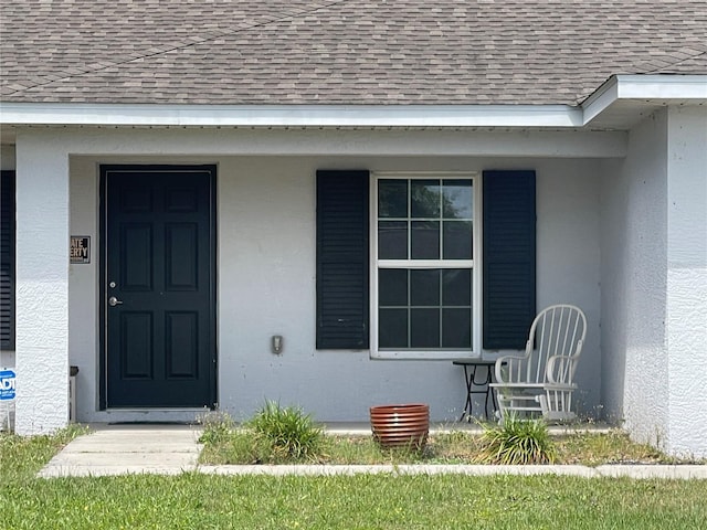 6306 Pecan Crse, Ocala, FL 34472 - doorway to property featuring roof with shingles and stucco siding