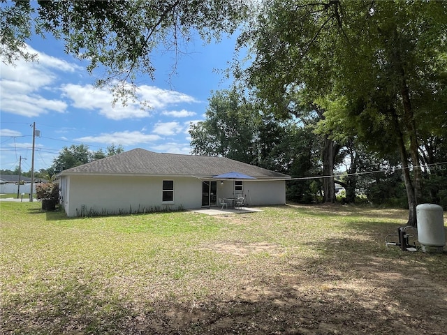 6306 Pecan Crse, Ocala, FL 34472 - rear view of property featuring a patio, a lawn, and stucco siding