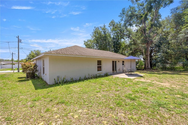 6306 Pecan Crse, Ocala, FL 34472 - back of property with a patio, a lawn, and stucco siding