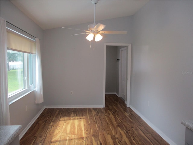 empty room with baseboards, ceiling fan, and wood finished floors