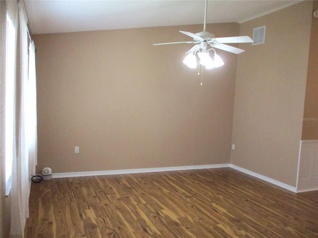 unfurnished room with baseboards, a ceiling fan, wood finished floors, and visible vents