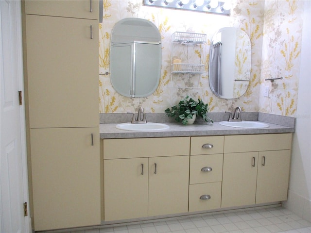 full bathroom featuring double vanity, a sink, and wallpapered walls
