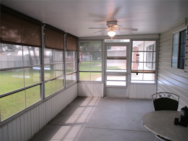 unfurnished sunroom featuring ceiling fan