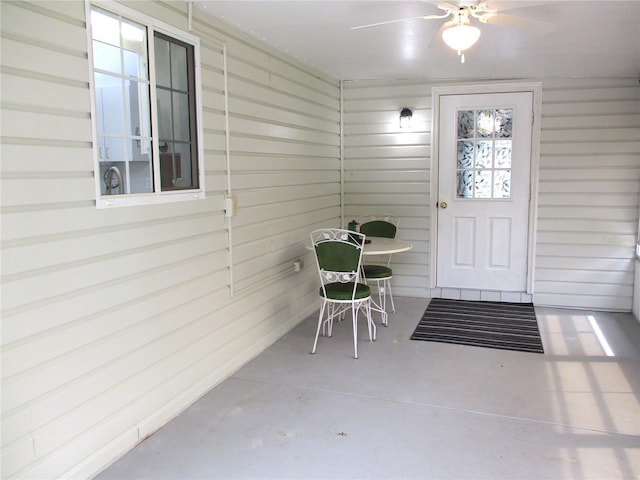 exterior space with ceiling fan