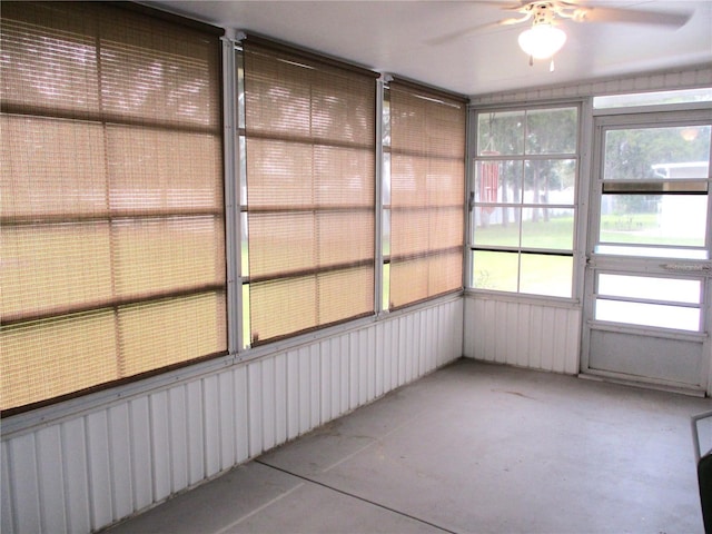 unfurnished sunroom featuring ceiling fan