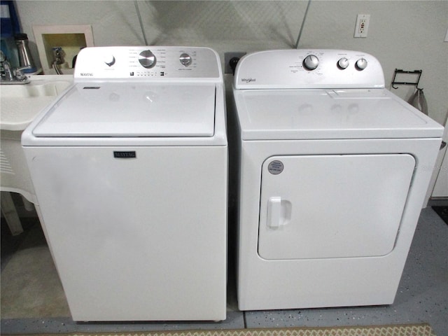 clothes washing area featuring independent washer and dryer and laundry area