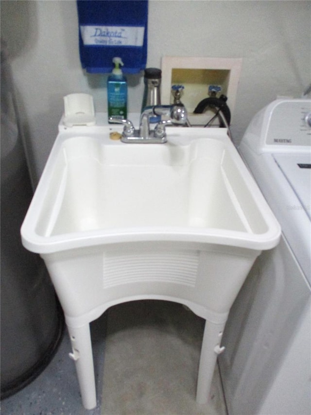interior details with washer / dryer and a sink