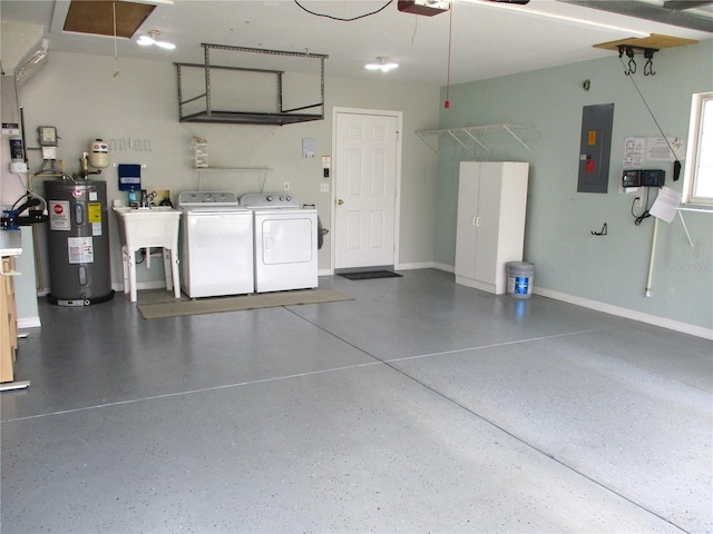 garage with electric panel, a sink, baseboards, separate washer and dryer, and electric water heater