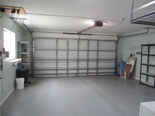 garage with baseboards and a garage door opener