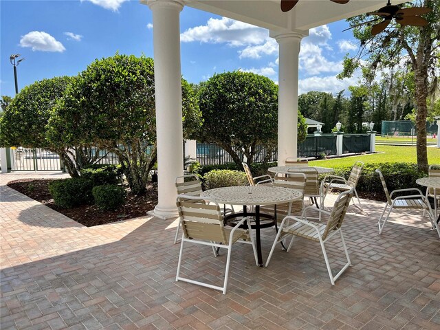 view of patio / terrace with ceiling fan, fence, and outdoor dining area