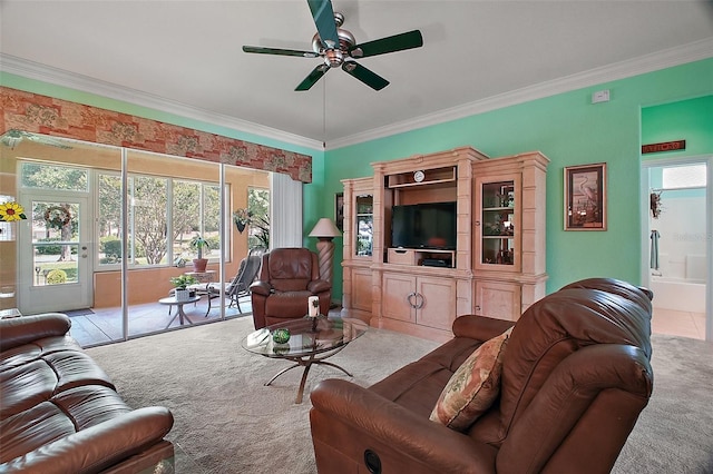 living room with ornamental molding, carpet, and ceiling fan