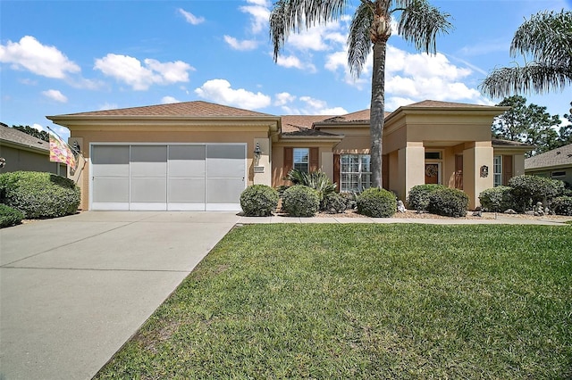 prairie-style home with a garage, stucco siding, driveway, and a front lawn