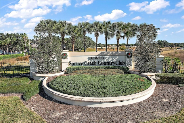 community sign featuring fence