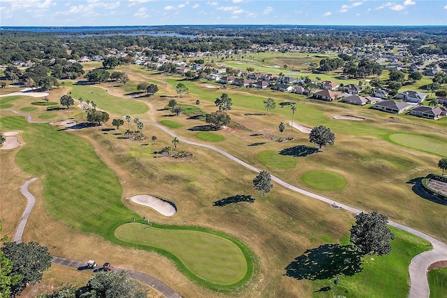 drone / aerial view featuring golf course view and a residential view
