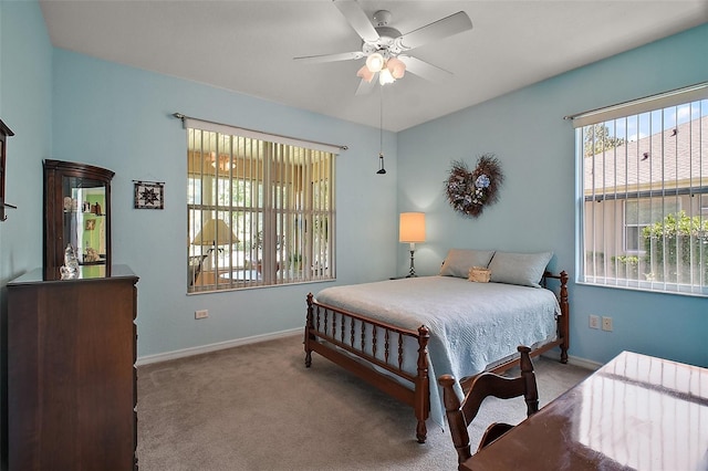 bedroom with carpet flooring, baseboards, and ceiling fan