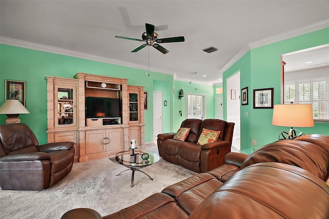 living area featuring crown molding, ceiling fan, carpet flooring, and visible vents