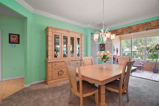 dining space with crown molding, baseboards, a notable chandelier, and light carpet