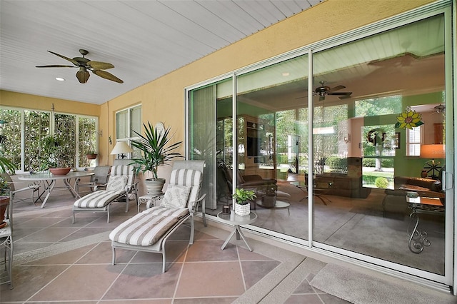 sunroom / solarium with ceiling fan and a wealth of natural light