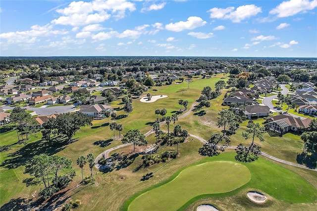 drone / aerial view with view of golf course and a residential view