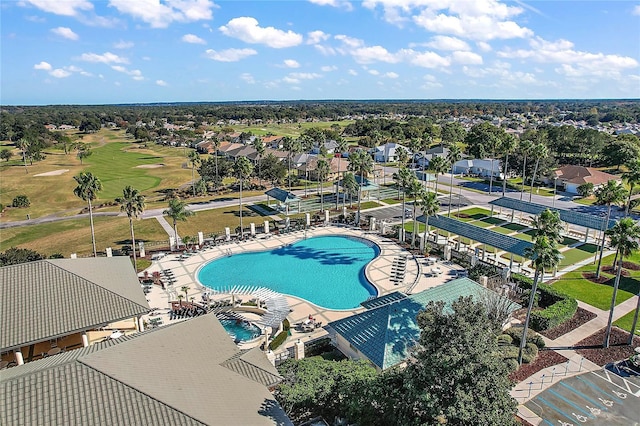 community pool with a residential view and view of golf course