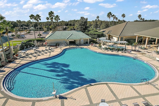 pool featuring fence and a patio area
