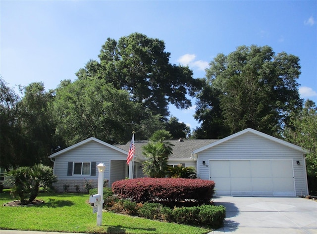 ranch-style house with a garage, concrete driveway, and a front lawn