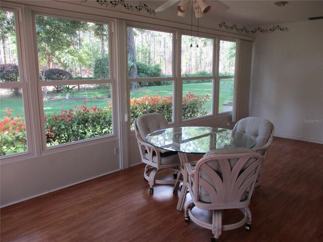 dining room with baseboards, ceiling fan, and wood finished floors