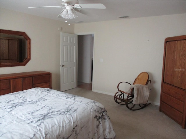 bedroom with baseboards, light carpet, a ceiling fan, and visible vents