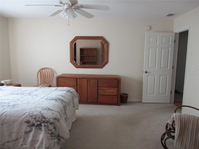 bedroom featuring ceiling fan, light colored carpet, and visible vents
