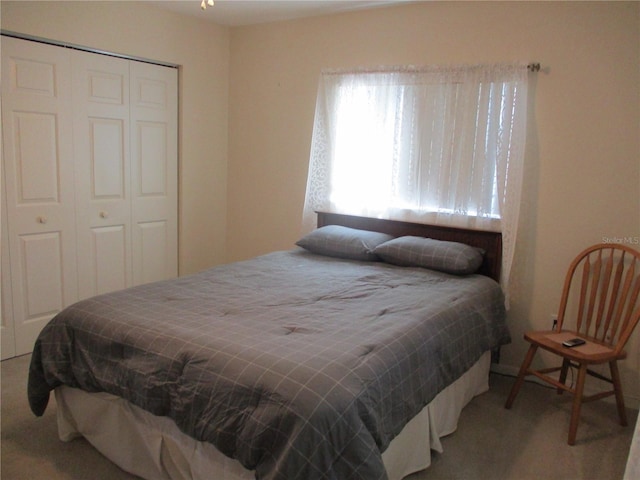 carpeted bedroom featuring a closet