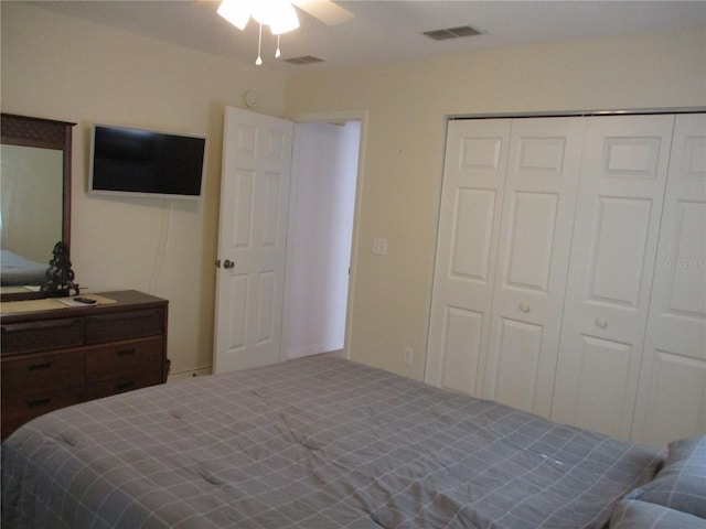 carpeted bedroom featuring visible vents, a ceiling fan, and a closet