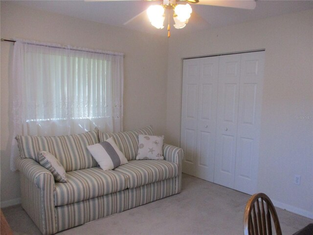 carpeted living room featuring ceiling fan
