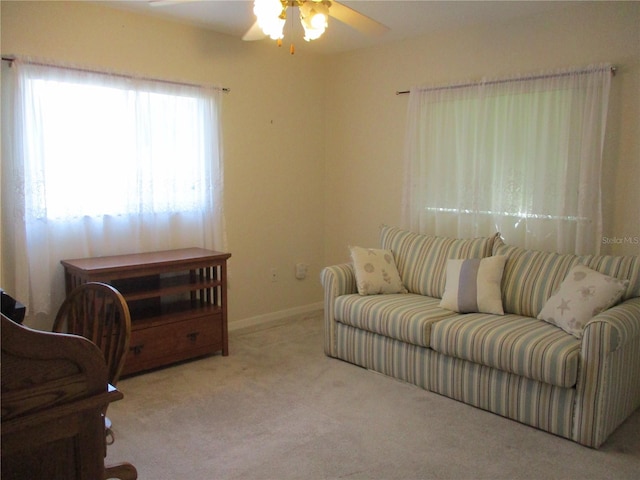 living area featuring ceiling fan and light carpet