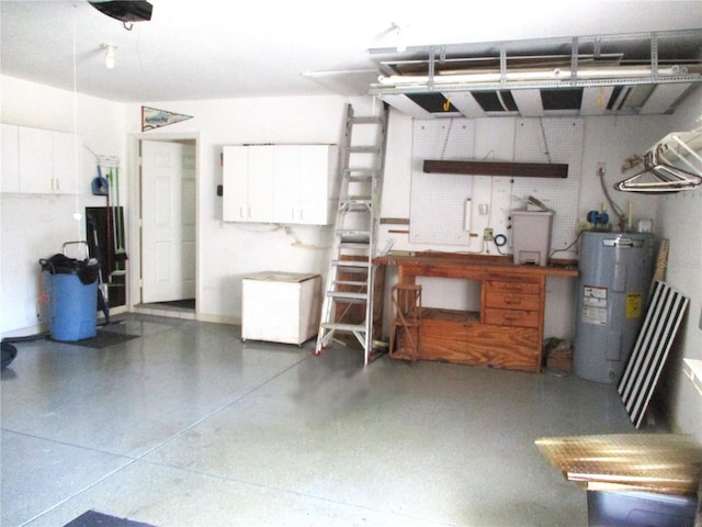 garage with a workshop area and electric water heater