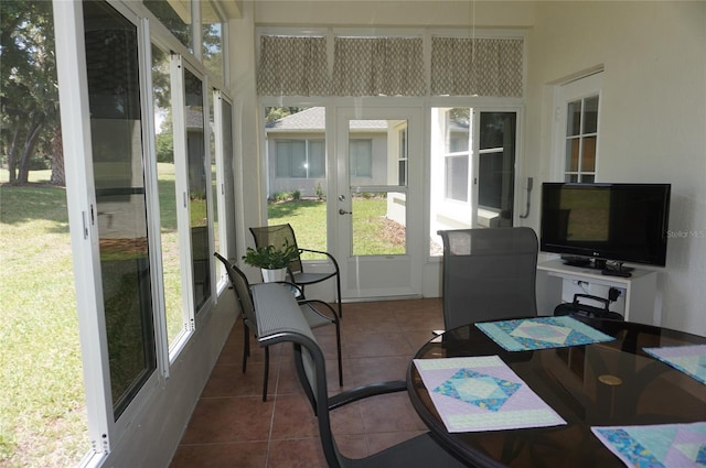 sunroom with tile patterned flooring and french doors