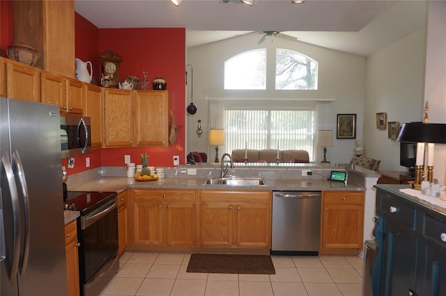 kitchen with a ceiling fan, a sink, light tile patterned floors, and stainless steel appliances