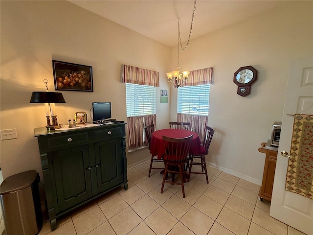 dining room featuring baseboards, a chandelier, and light tile patterned floors