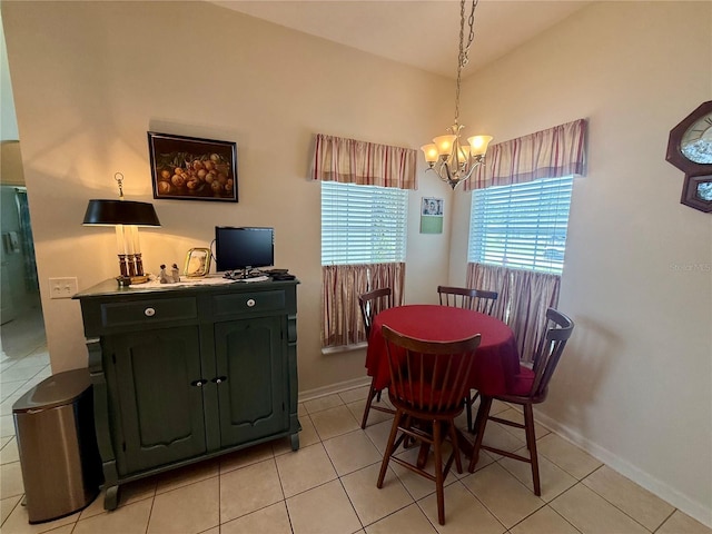 dining space with baseboards, light tile patterned flooring, and a notable chandelier