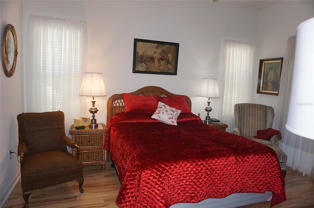 bedroom featuring baseboards and wood finished floors