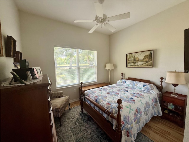 bedroom featuring baseboards, ceiling fan, and wood finished floors