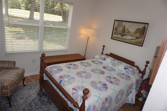bedroom featuring baseboards and wood finished floors